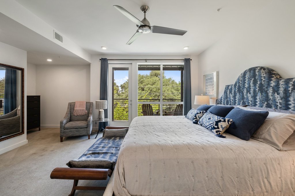 2003 Wilson Street, Unit 3 Austin, TX 78704 - Photo 13 of 27 a bedroom with a bed a couch and a large window