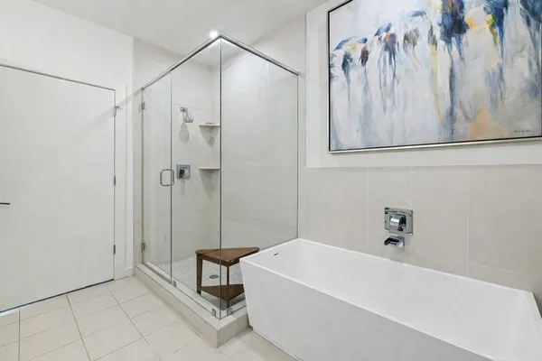 a bathroom with a bathtub and shower