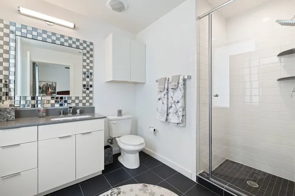 a bathroom with a sink toilet and shower