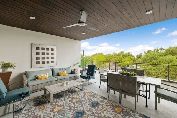 a living room with patio furniture and a garden
