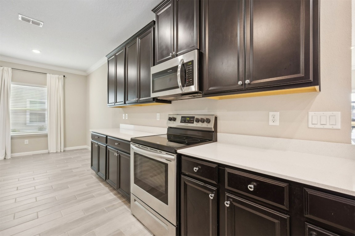 85237 Fall River Parkway Fernandina Beach, FL 32034 - Photo 15 of 82 a kitchen with stainless steel appliances granite countertop a sink and a stove