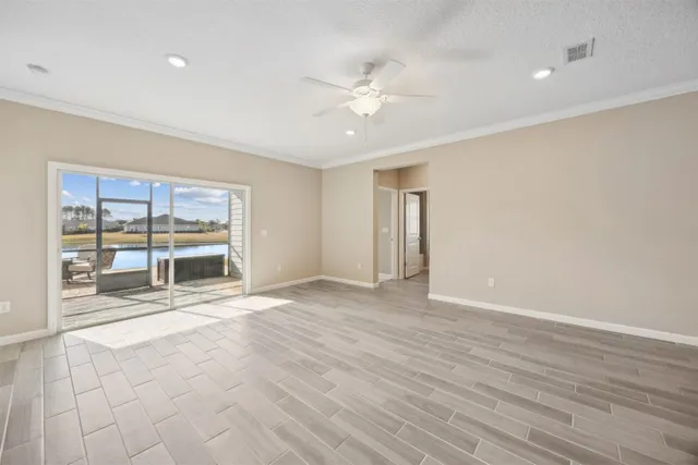 an empty room with closet and a chandelier fan