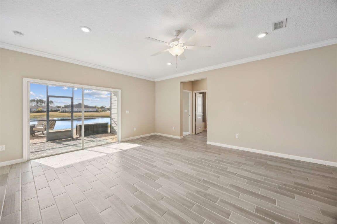 85237 Fall River Parkway Fernandina Beach, FL 32034 - Photo 22 of 82 a view of an empty room with a fireplace and a large window