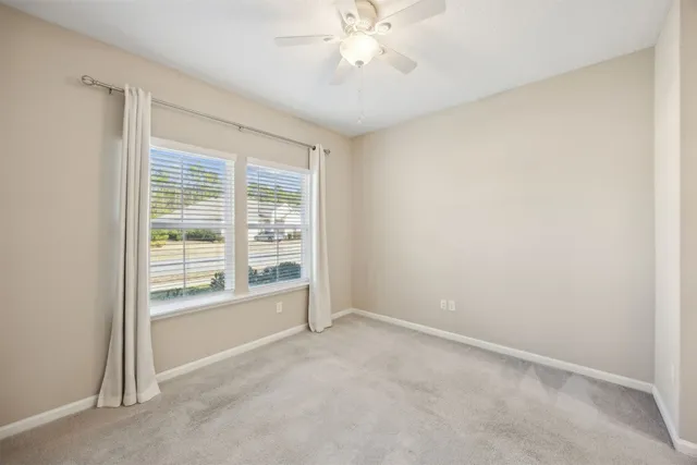 a backyard of a house with lots of green space and lake view