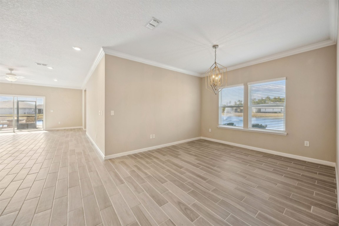 85237 Fall River Parkway Fernandina Beach, FL 32034 - Photo 10 of 82 wooden floor in an empty room with a window