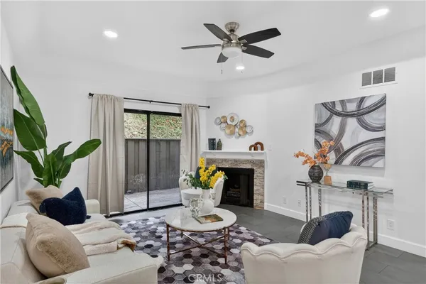 a living room with furniture potted plant and a fireplace