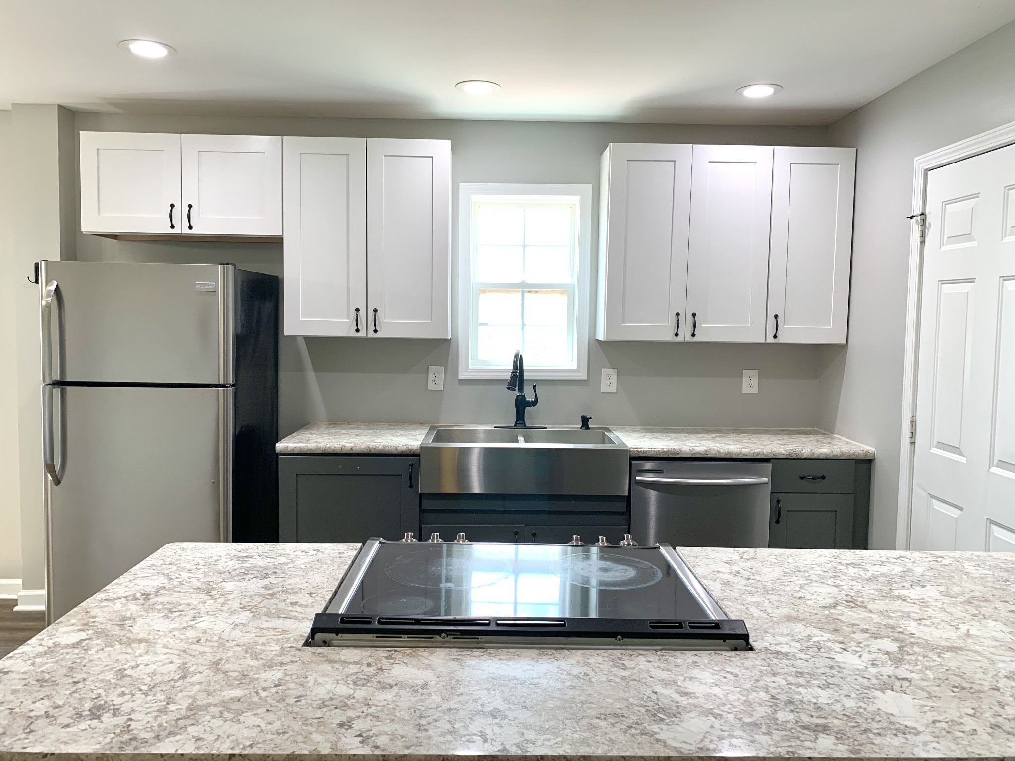 819 Stableford Road Oak Grove, KY 42262 - Photo 13 of 50 a kitchen with kitchen island granite countertop a refrigerator stove a sink and dishwasher with wooden floor