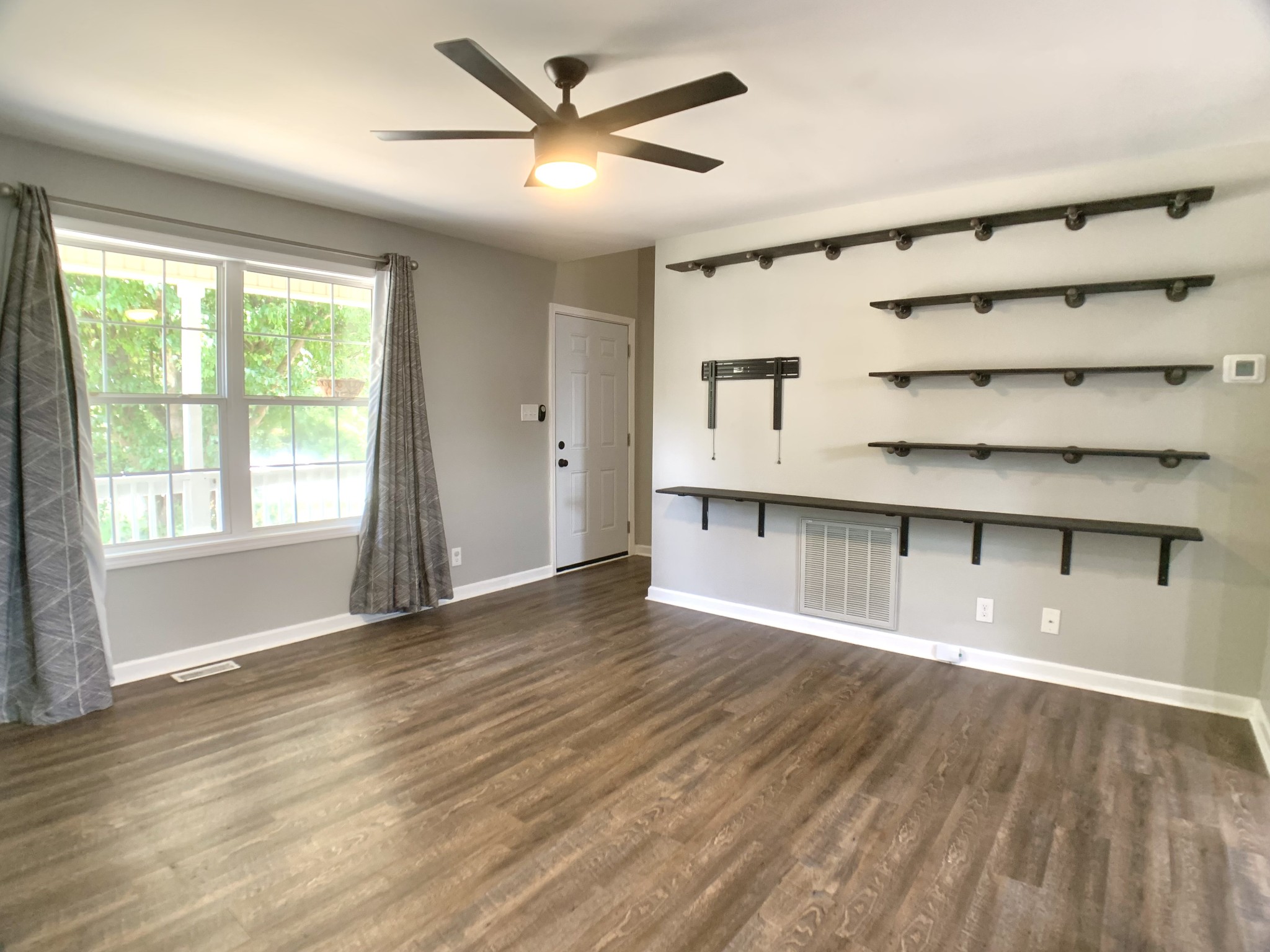 819 Stableford Road Oak Grove, KY 42262 - Photo 5 of 50 a view of an empty room with a window and wooden floor
