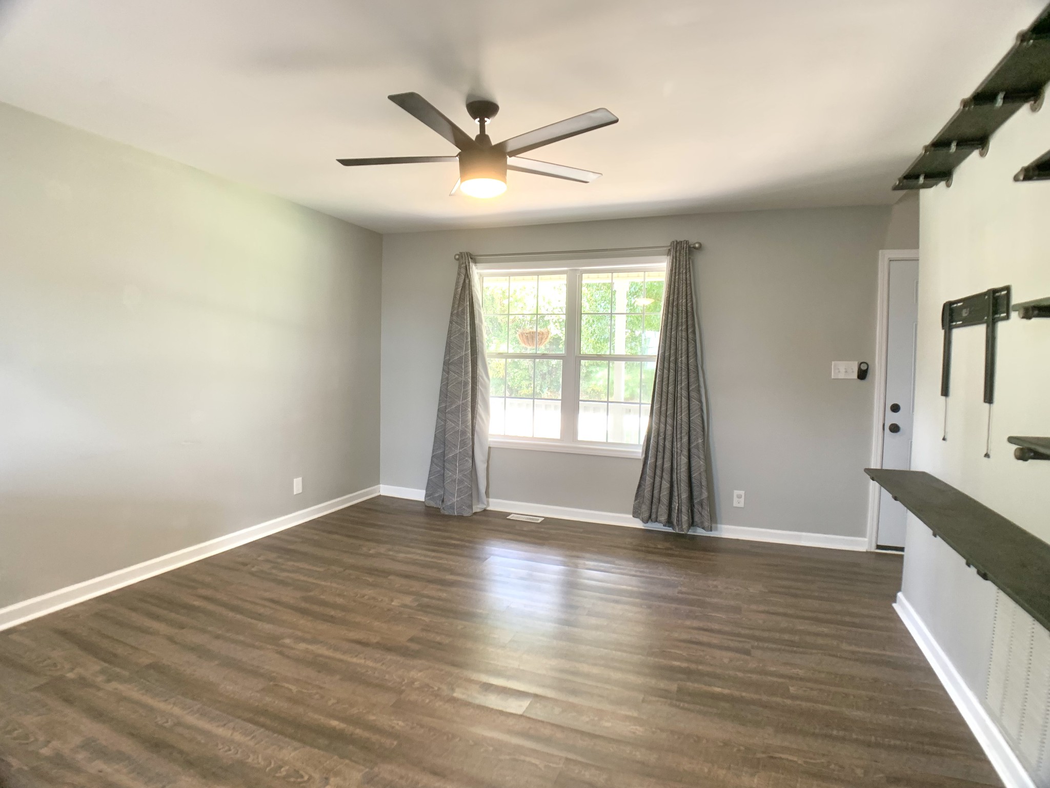 819 Stableford Road Oak Grove, KY 42262 - Photo 8 of 50 an empty room with wooden floor fan and windows
