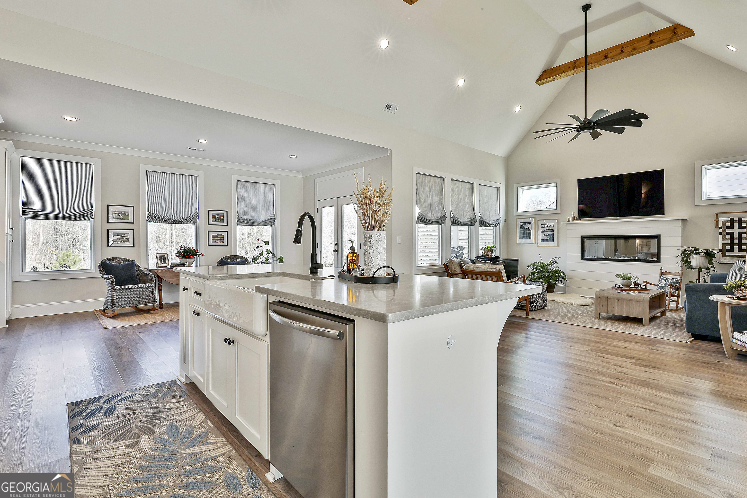 335 Werner Way Senoia, GA 30276 - Photo 17 of 51 a living room with stainless steel appliances granite countertop furniture a fireplace a flat screen tv and couches