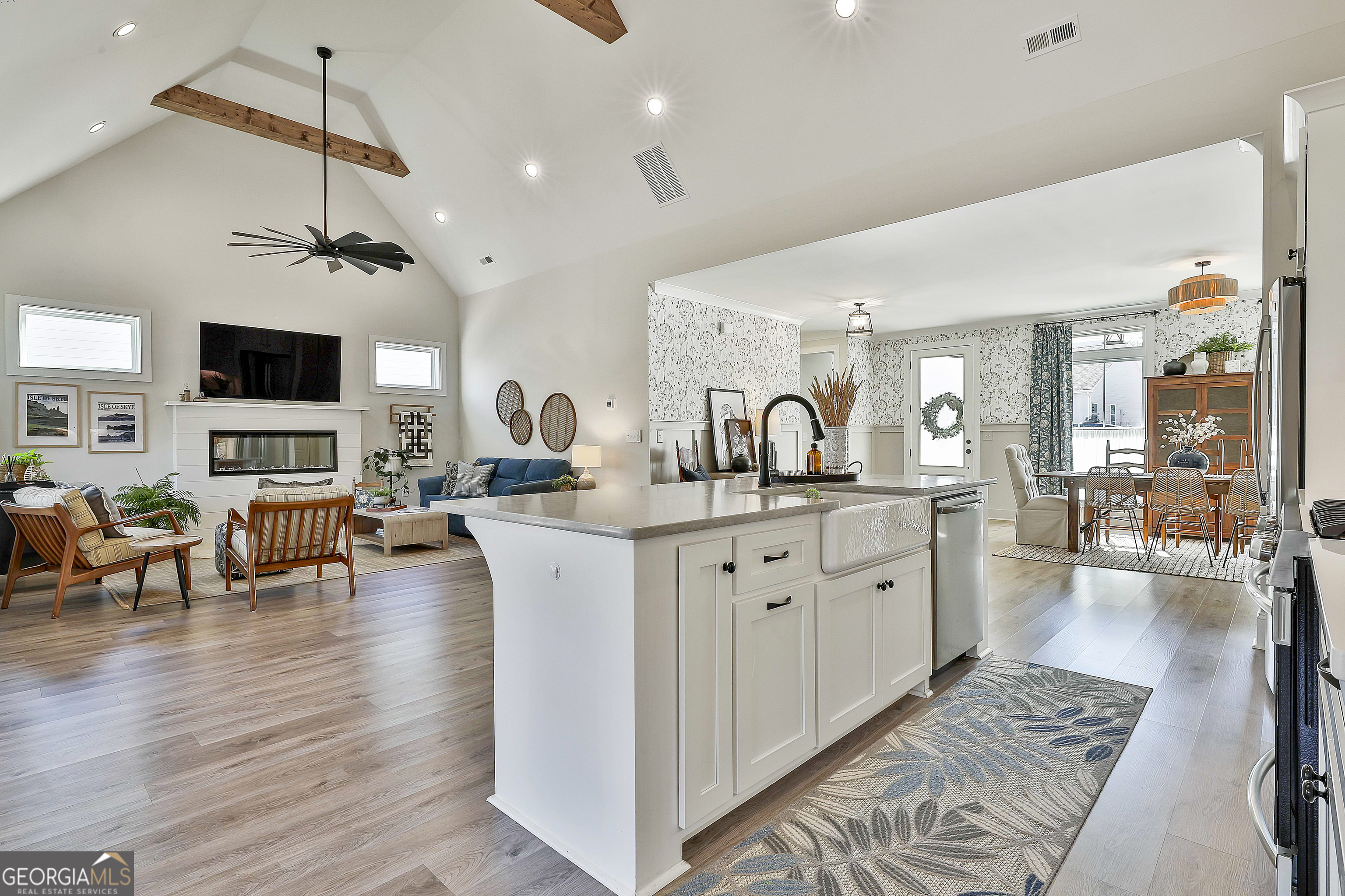 335 Werner Way Senoia, GA 30276 - Photo 18 of 51 a large living room with stainless steel appliances granite countertop couches a fireplace with wooden floor