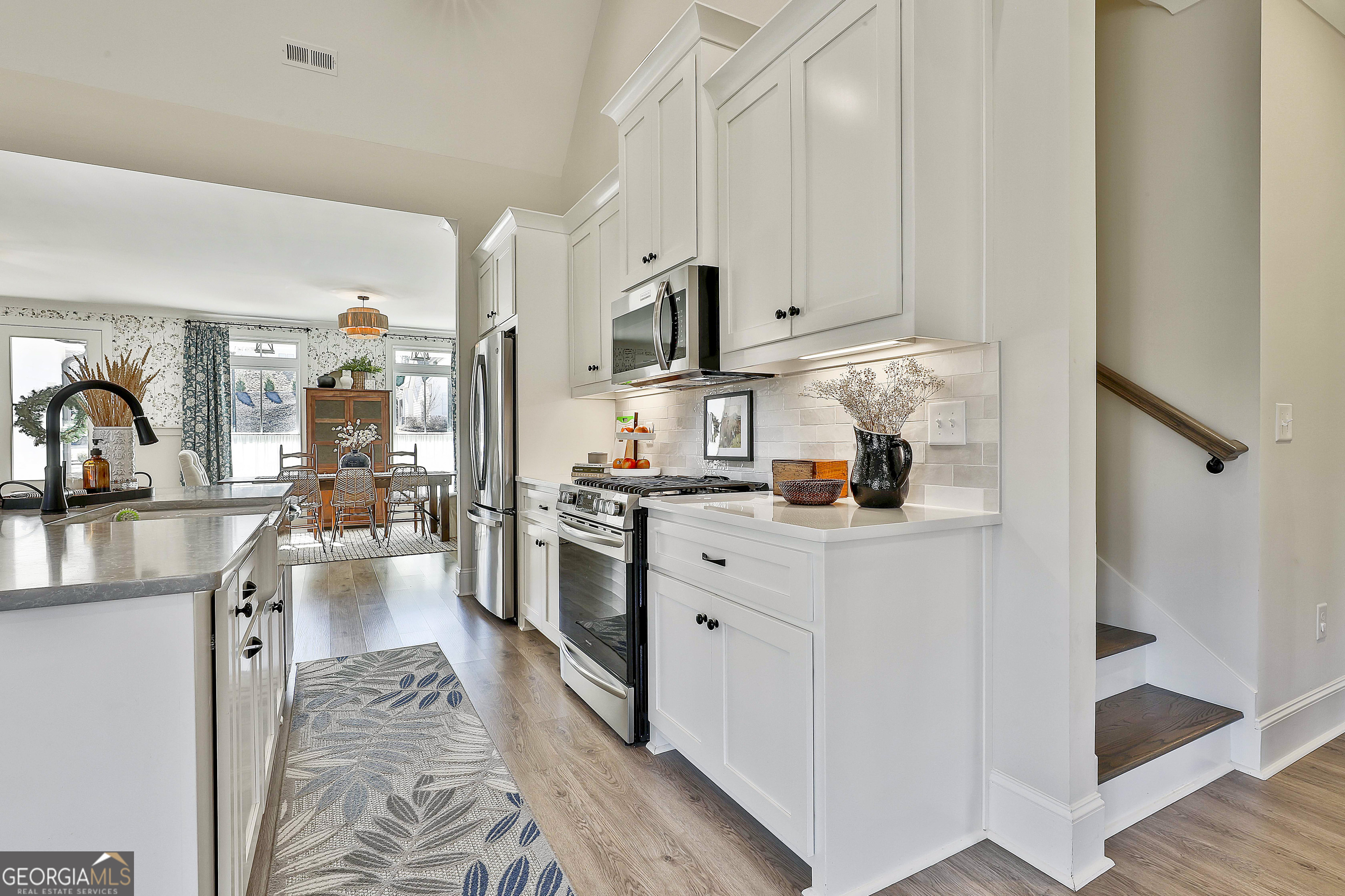 335 Werner Way Senoia, GA 30276 - Photo 19 of 51 a kitchen with stainless steel appliances granite countertop a refrigerator sink and white cabinets