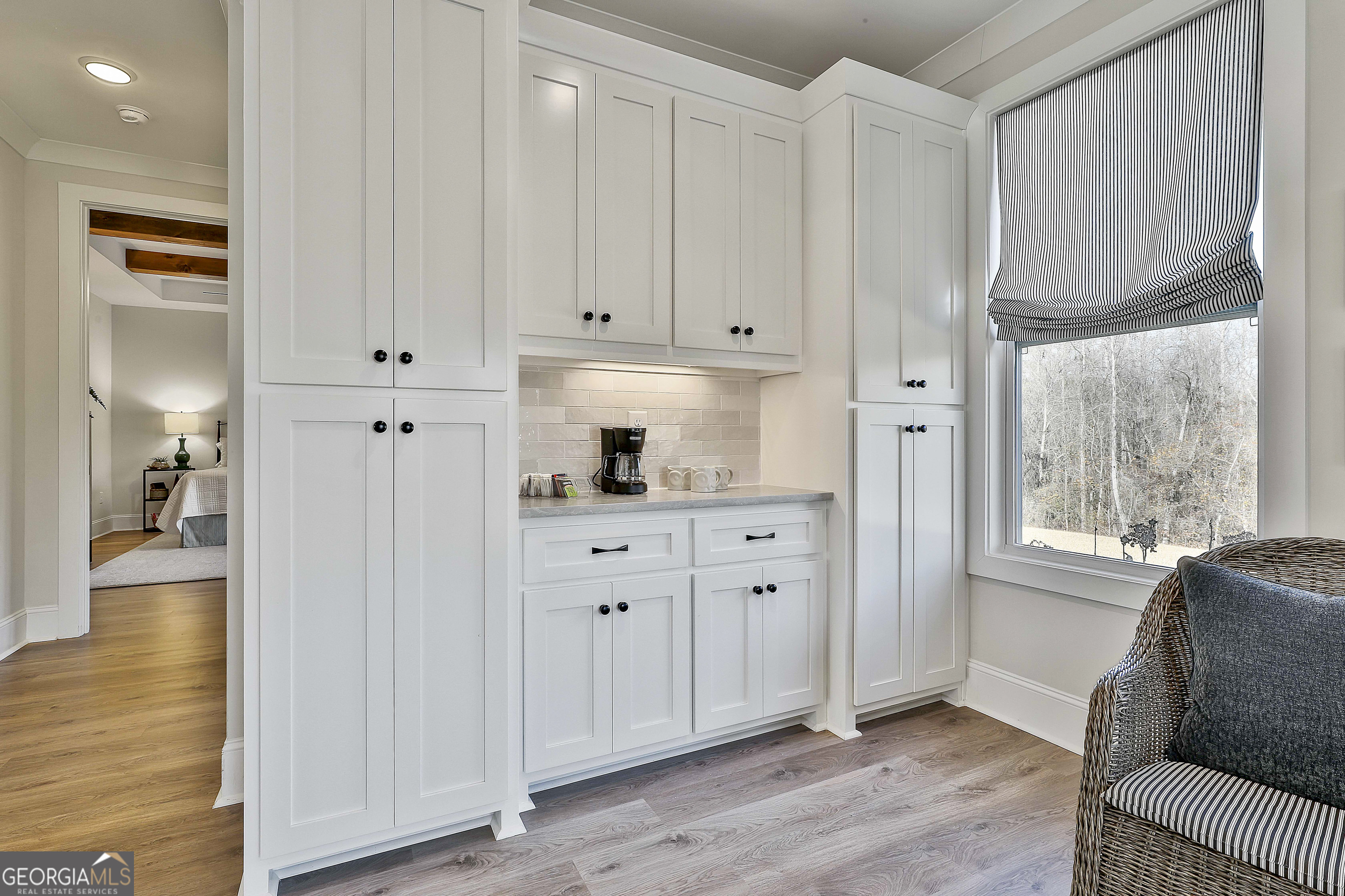 335 Werner Way Senoia, GA 30276 - Photo 22 of 51 a hallway with white cabinets and wooden floor
