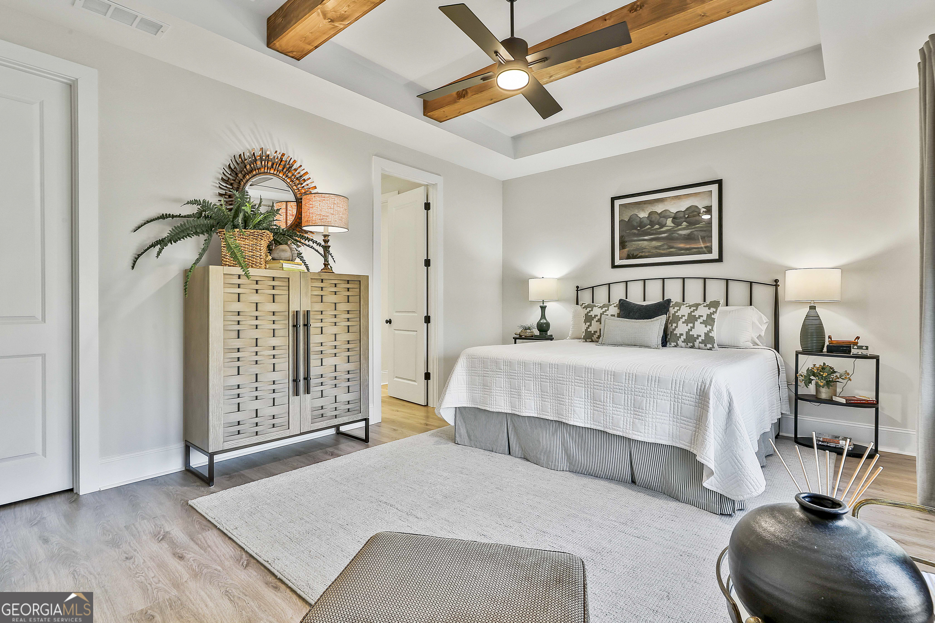 335 Werner Way Senoia, GA 30276 - Photo 31 of 51 a bedroom with a large bed and a chandelier