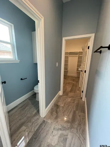 a view of walk in closet with empty racks