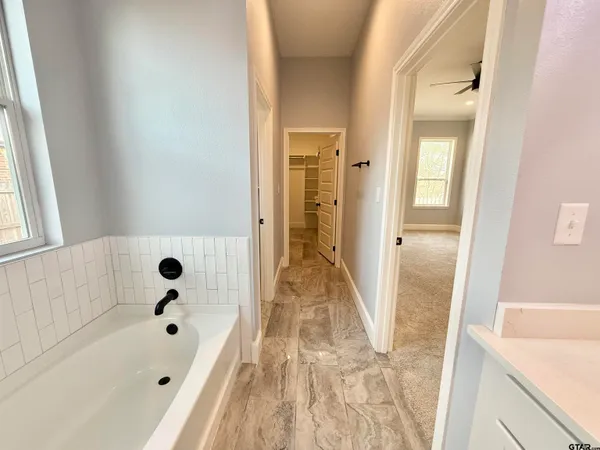 a bathroom with a bathtub and a shower