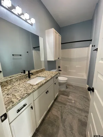 an empty room with a window and ceiling fan