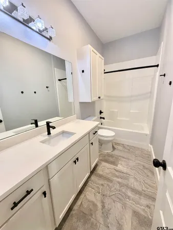 an empty room with closet and a chandelier fan
