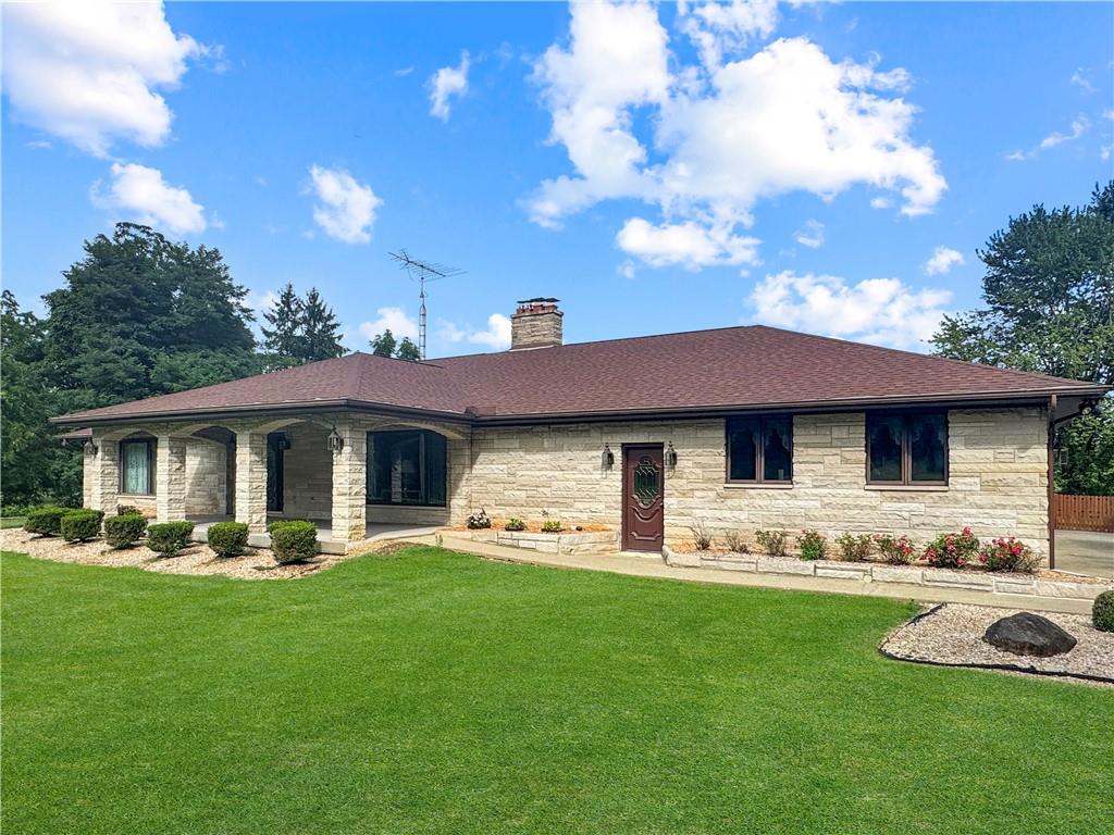 a front view of a house with garden