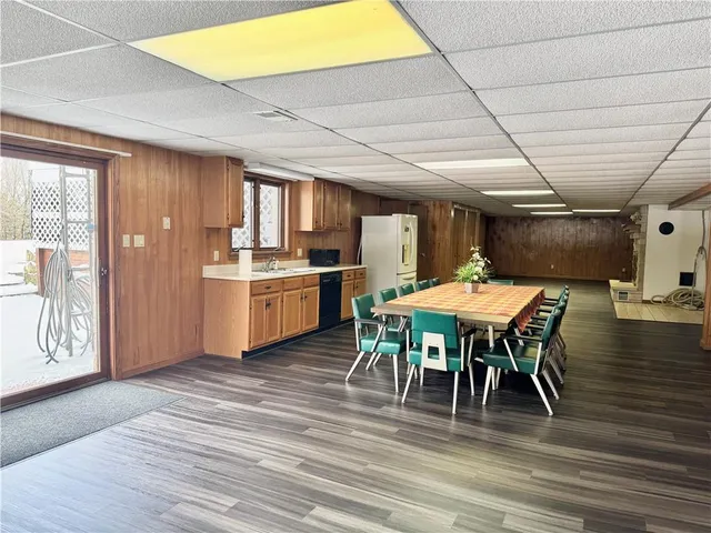 an empty room with wooden floor and a window