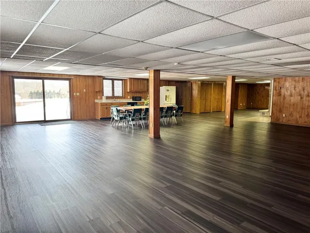 a spacious bedroom with a bed and wooden floor