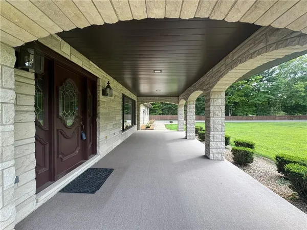 a view of a porch with furniture and garden