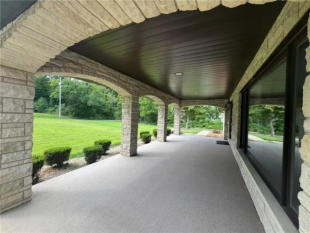 a view of a house with backyard and porch