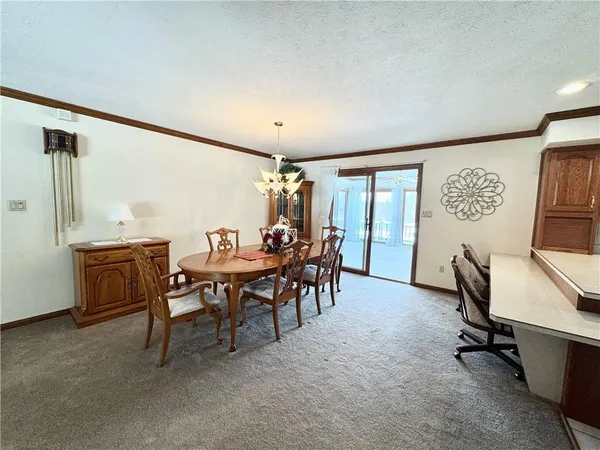 a view of a dining room with furniture and a table