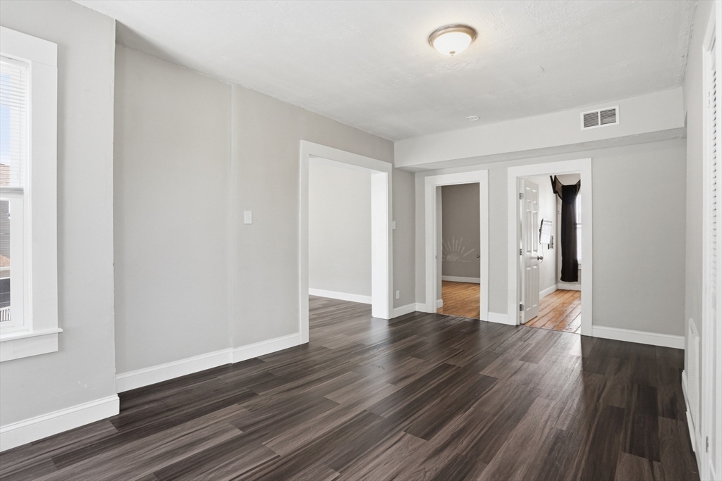 196 Irving Street Fall River, MA 02723 - Photo 10 of 34 a view of an empty room with wooden floor and a window