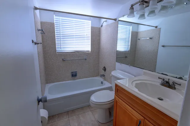 a bathroom with a sink a toilet and bathtub
