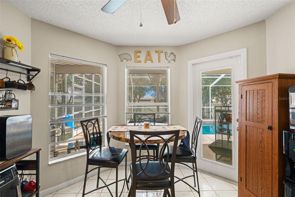12292 Ronald Street Spring Hill, FL 34609 - Photo 4 of 18 a view of a dining room with furniture window and outside view