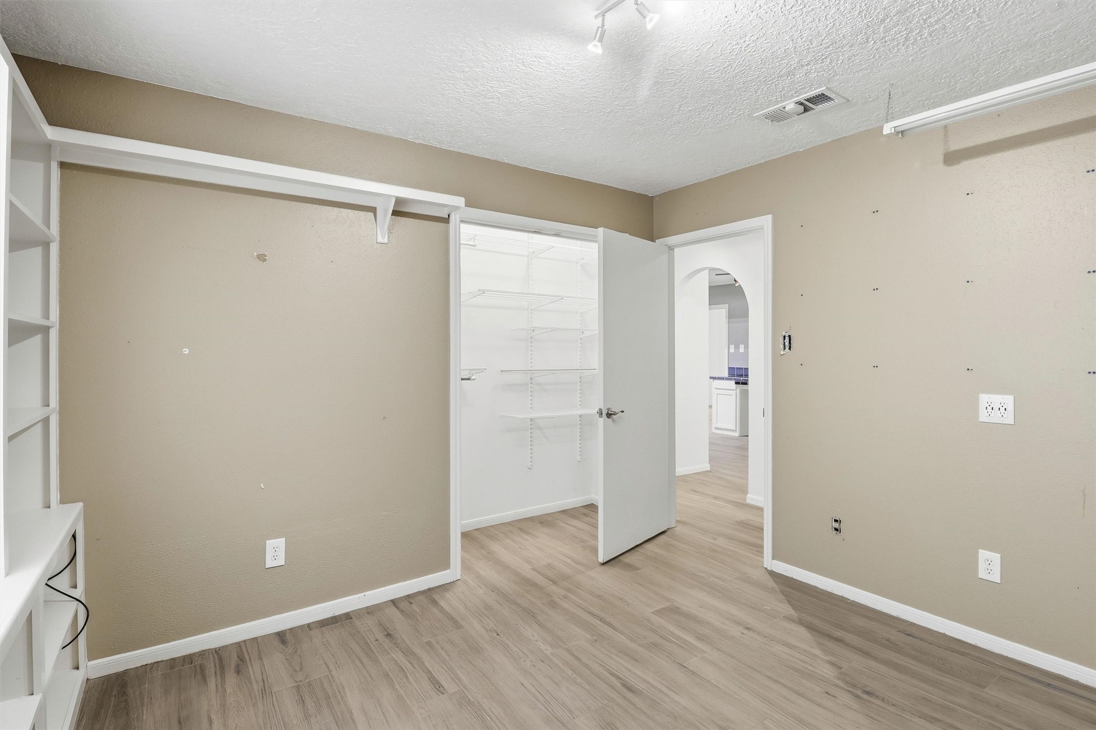 22923 Tomball Cemetery Road Tomball, TX 77377 - Photo 32 of 50 This 3rd bedroom has custom shelving around the perimeter and an open closet design.