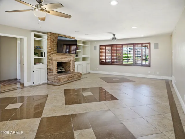 a view of a swimming pool with a yard and palm trees