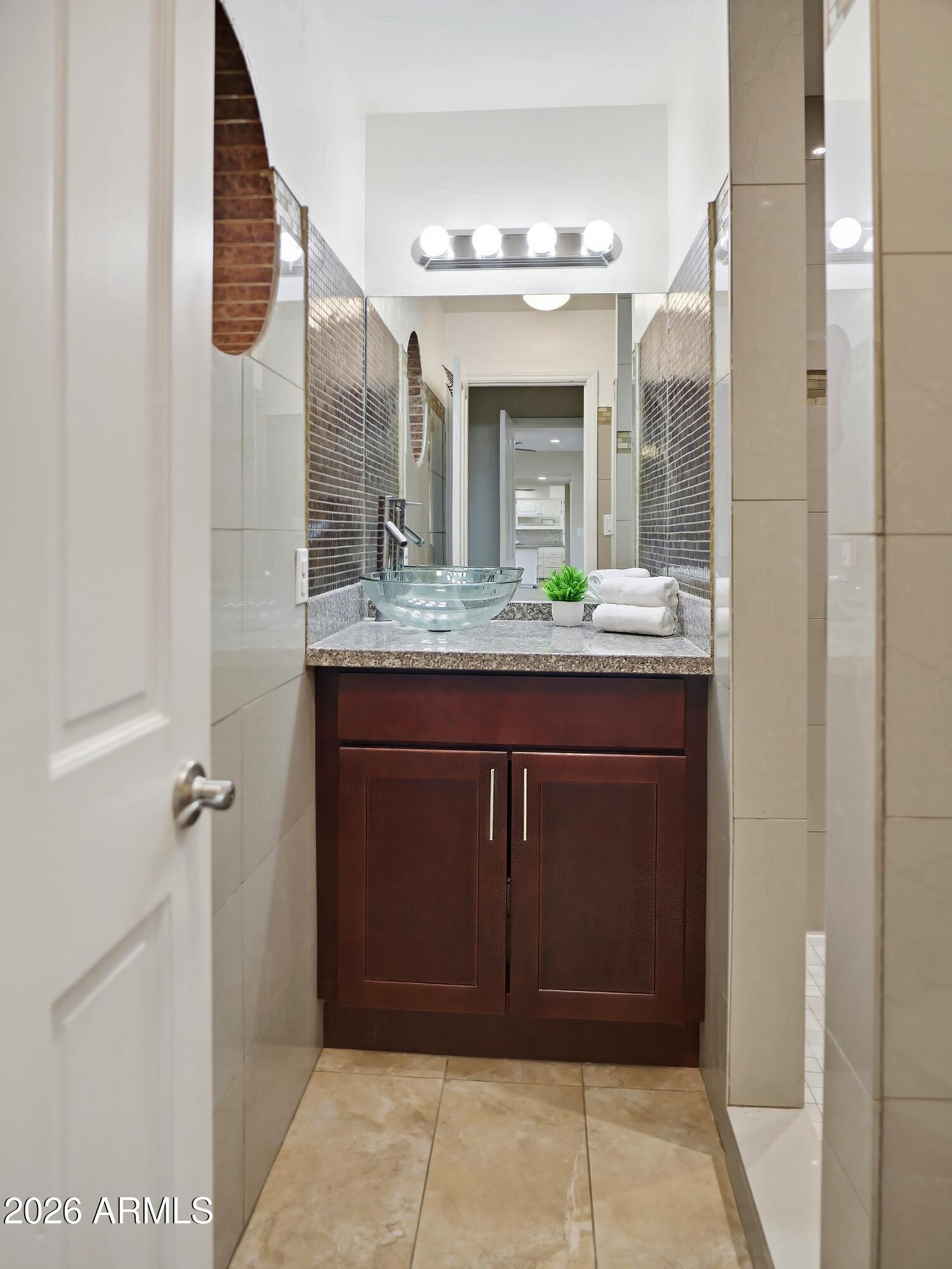 3154 East Inverness Avenue Mesa, AZ 85204 - Photo 17 of 70 a bathroom with a granite countertop sink and a mirror