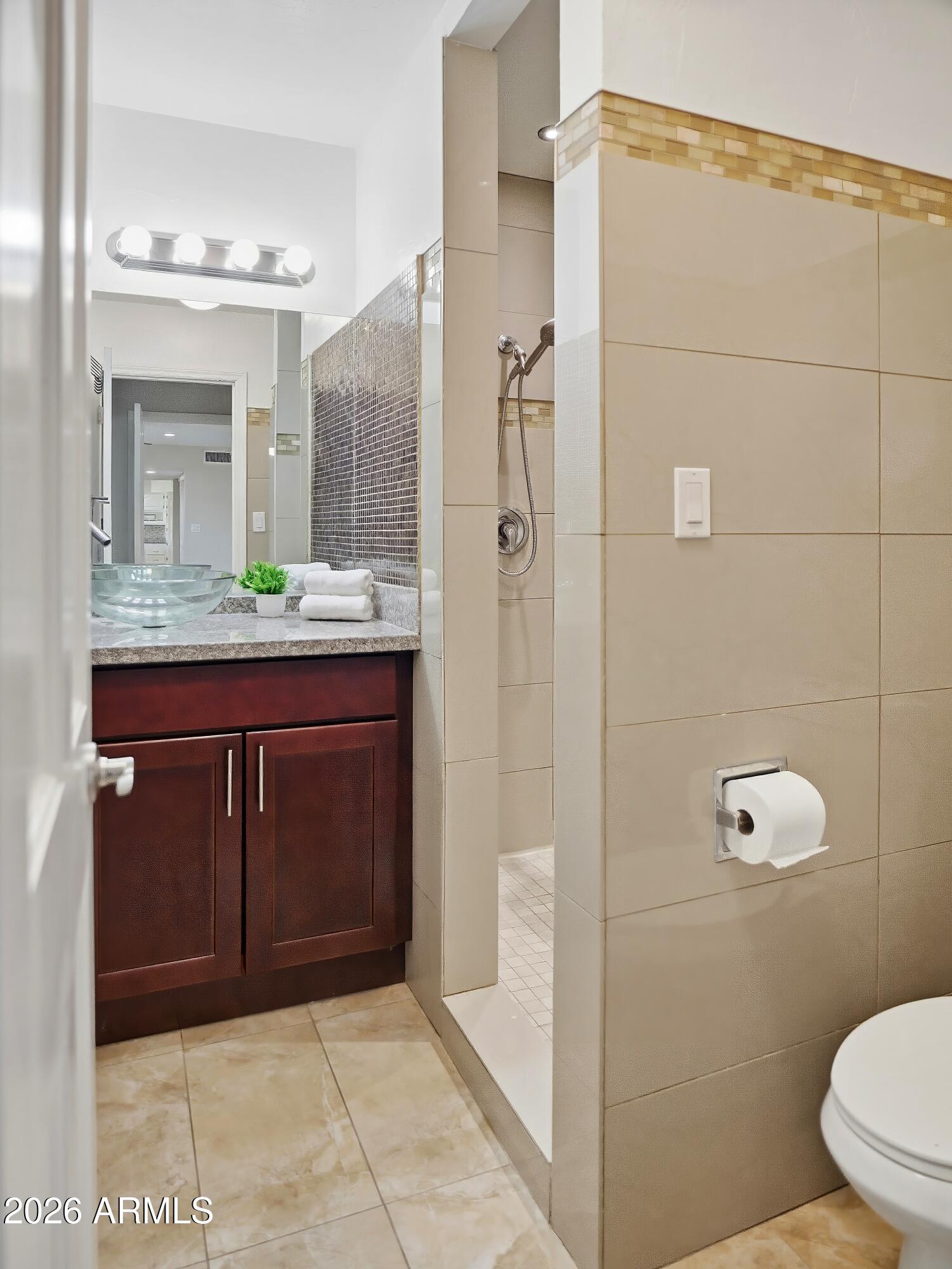 3154 East Inverness Avenue Mesa, AZ 85204 - Photo 18 of 70 a bathroom with a granite countertop sink a toilet and shower