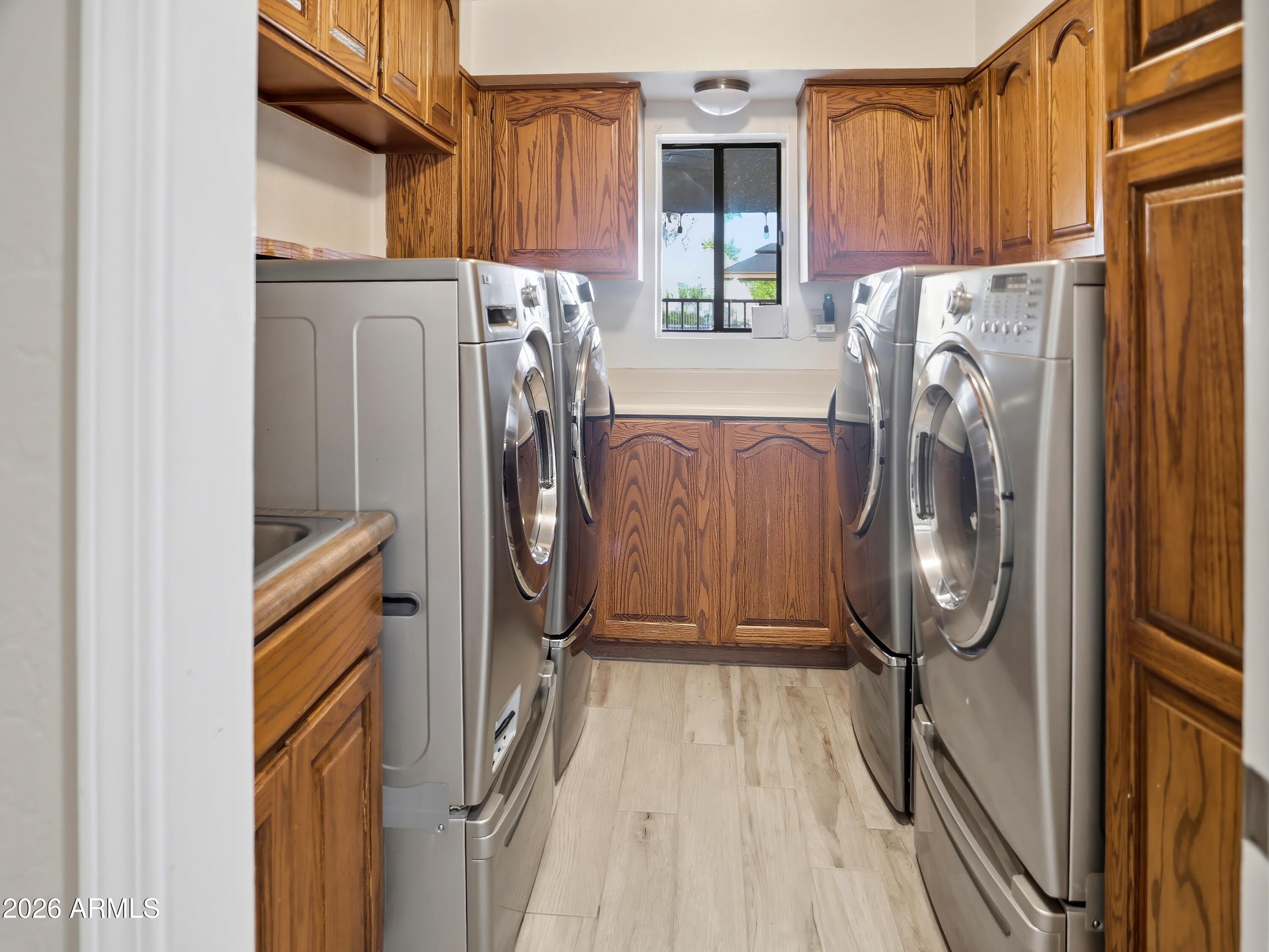 3154 East Inverness Avenue Mesa, AZ 85204 - Photo 19 of 70 a view of a storage and utility room with washer and dryer