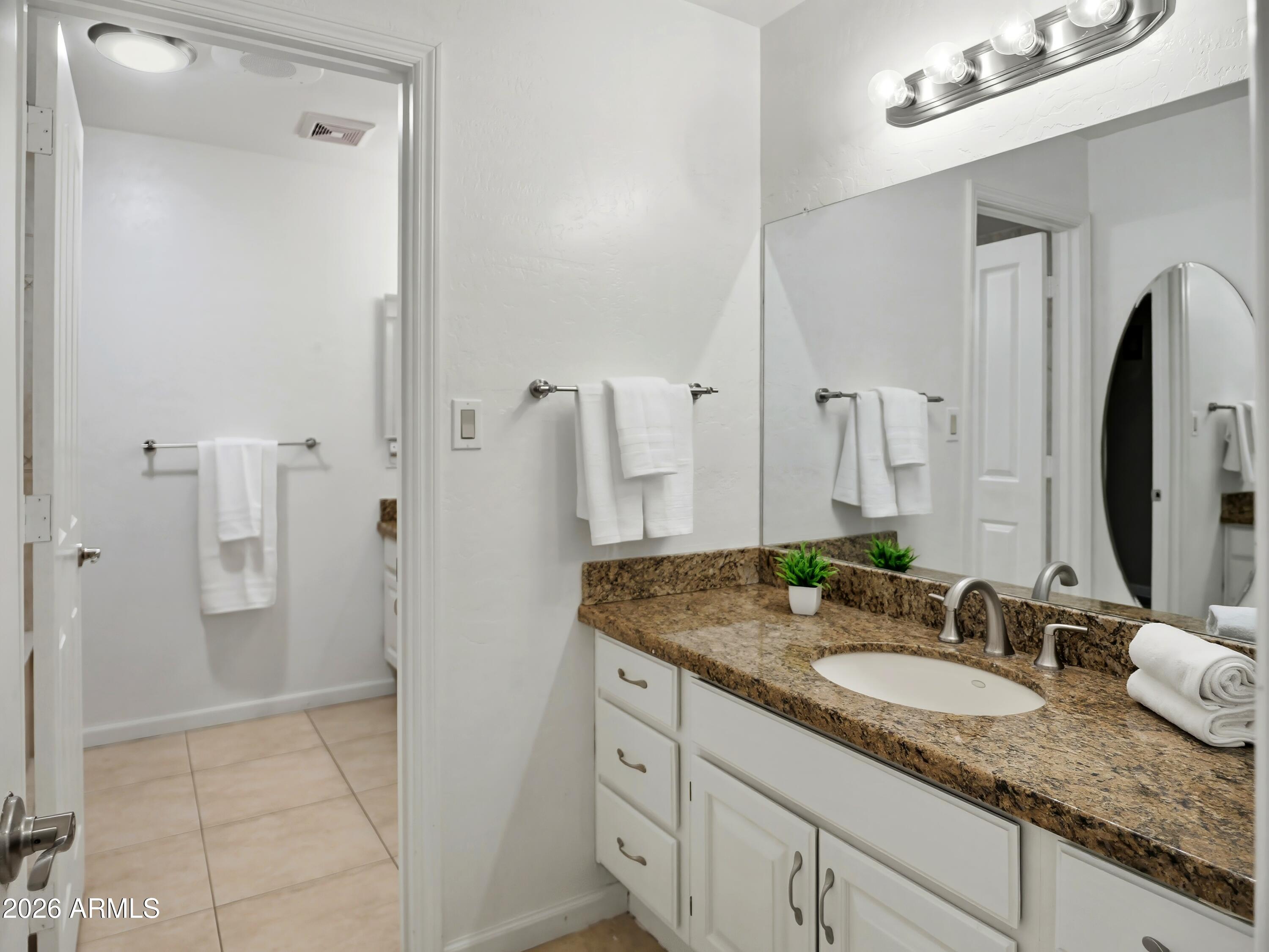 3154 East Inverness Avenue Mesa, AZ 85204 - Photo 47 of 70 a bathroom with a granite countertop double vanity sink and a mirror