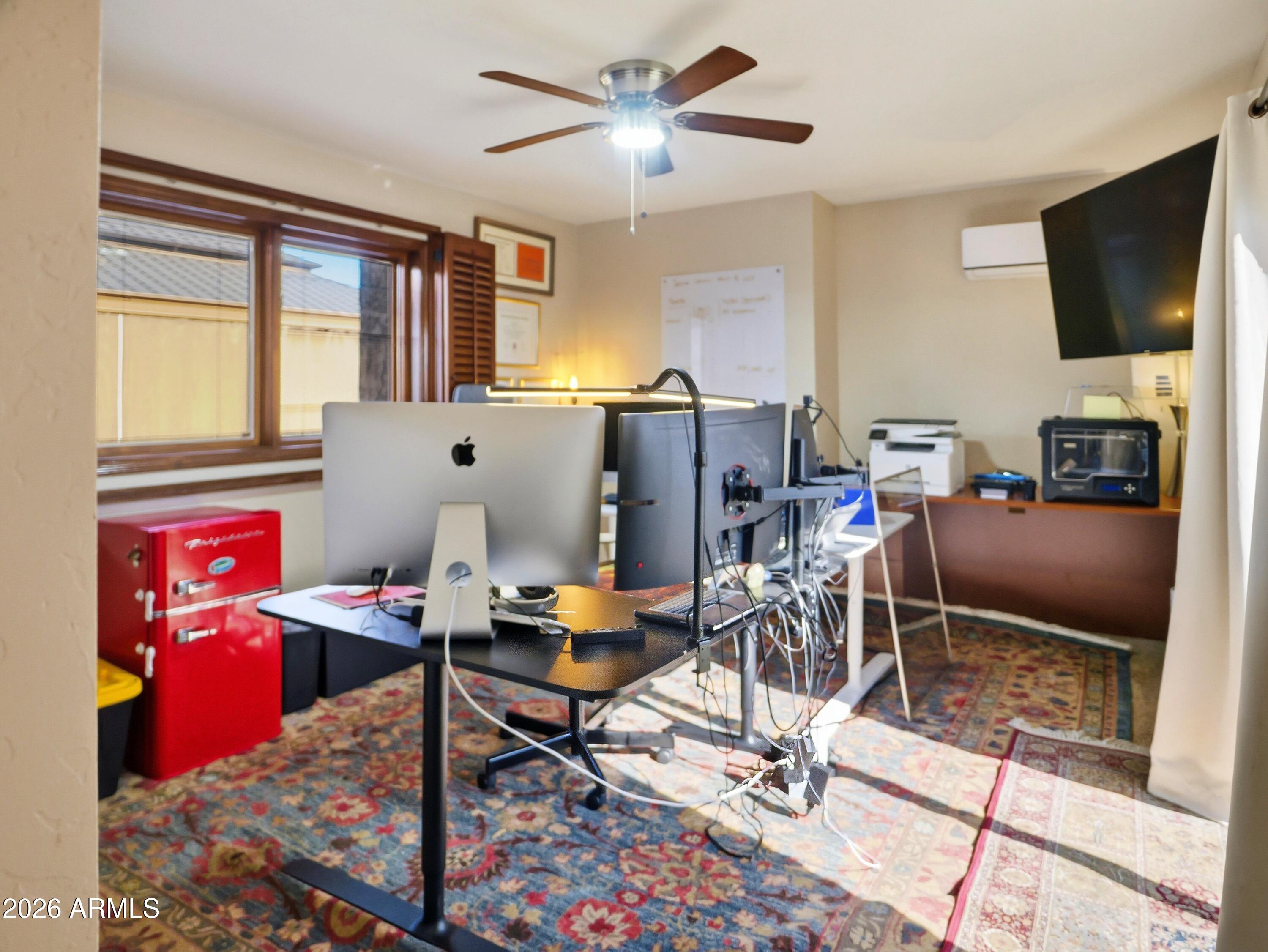 3154 East Inverness Avenue Mesa, AZ 85204 - Photo 60 of 70 a work room with furniture and a flat screen tv