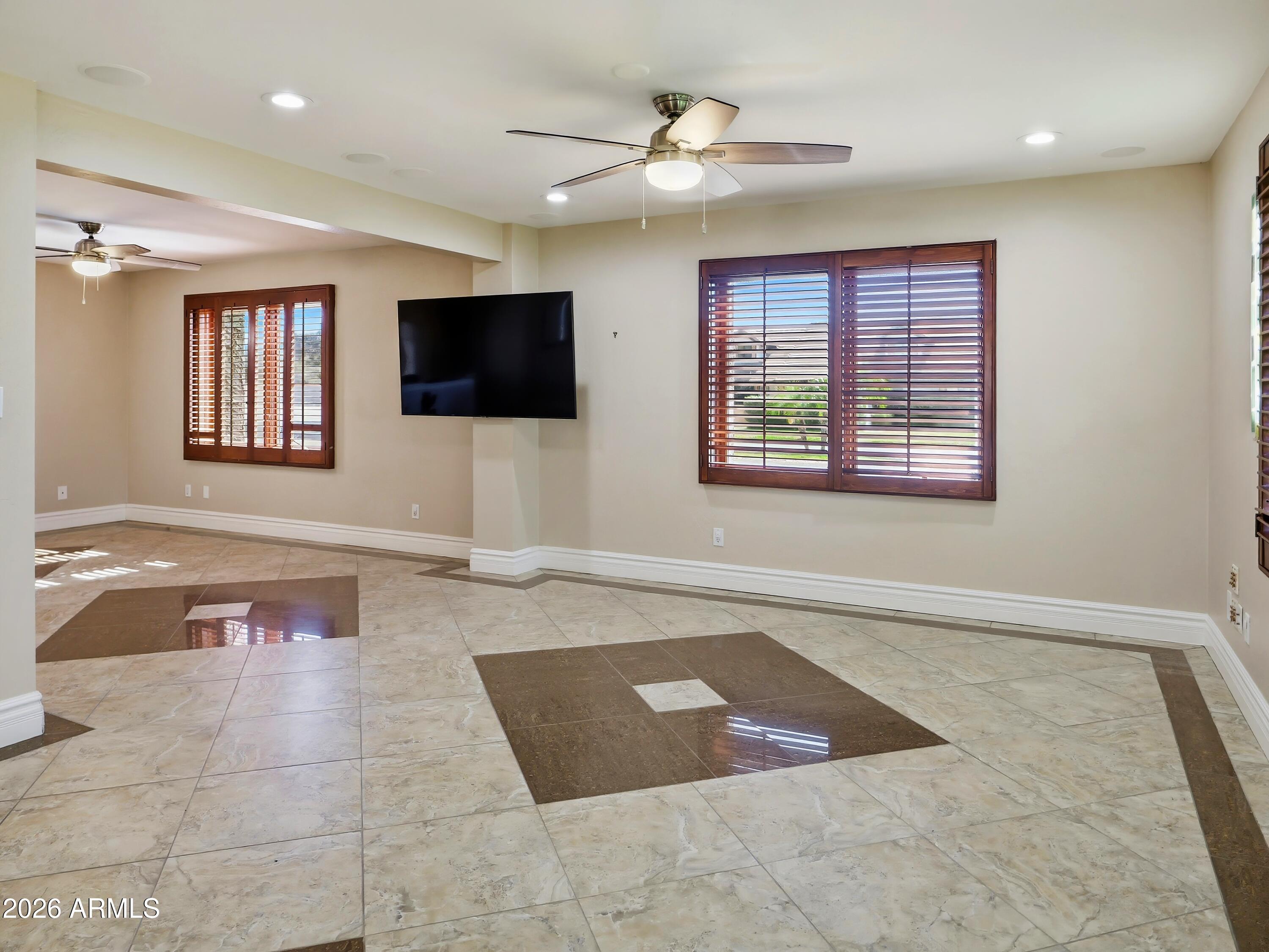 3154 East Inverness Avenue Mesa, AZ 85204 - Photo 9 of 70 a living room with furniture and a flat screen tv
