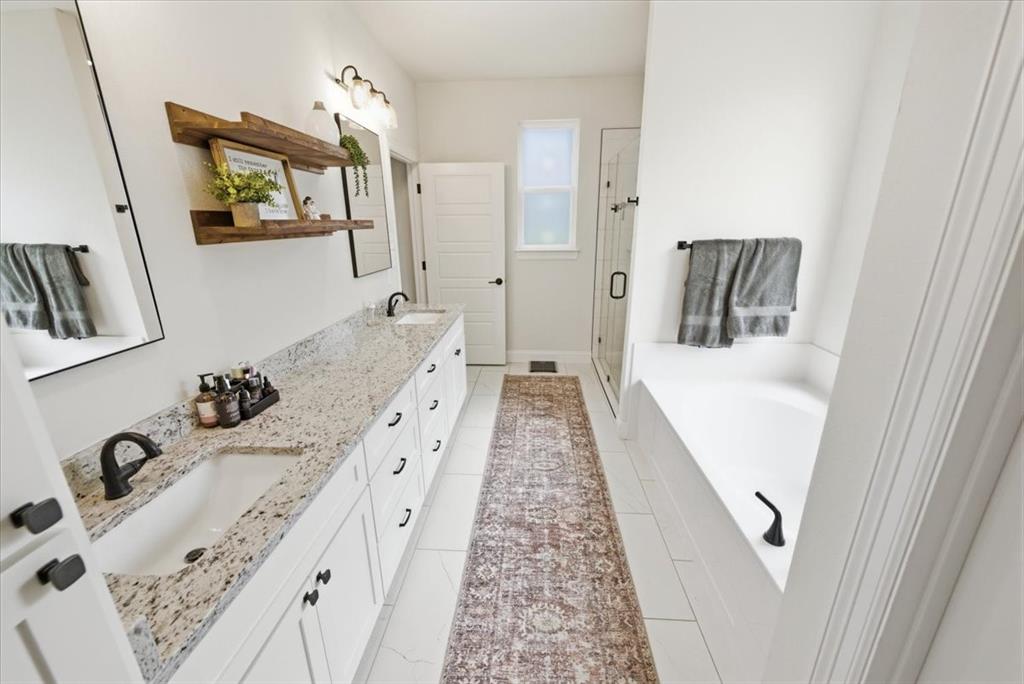 720 Whirlaway Road Hewitt, TX 76643 - Photo 34 of 35 Bathroom with double vanity, a bath, and a stall shower