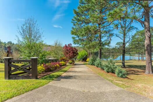 486 Ridge Lake Road Crestview, FL 32536 - Photo 3 of 87 a view of a garden with a bench in front of the house
