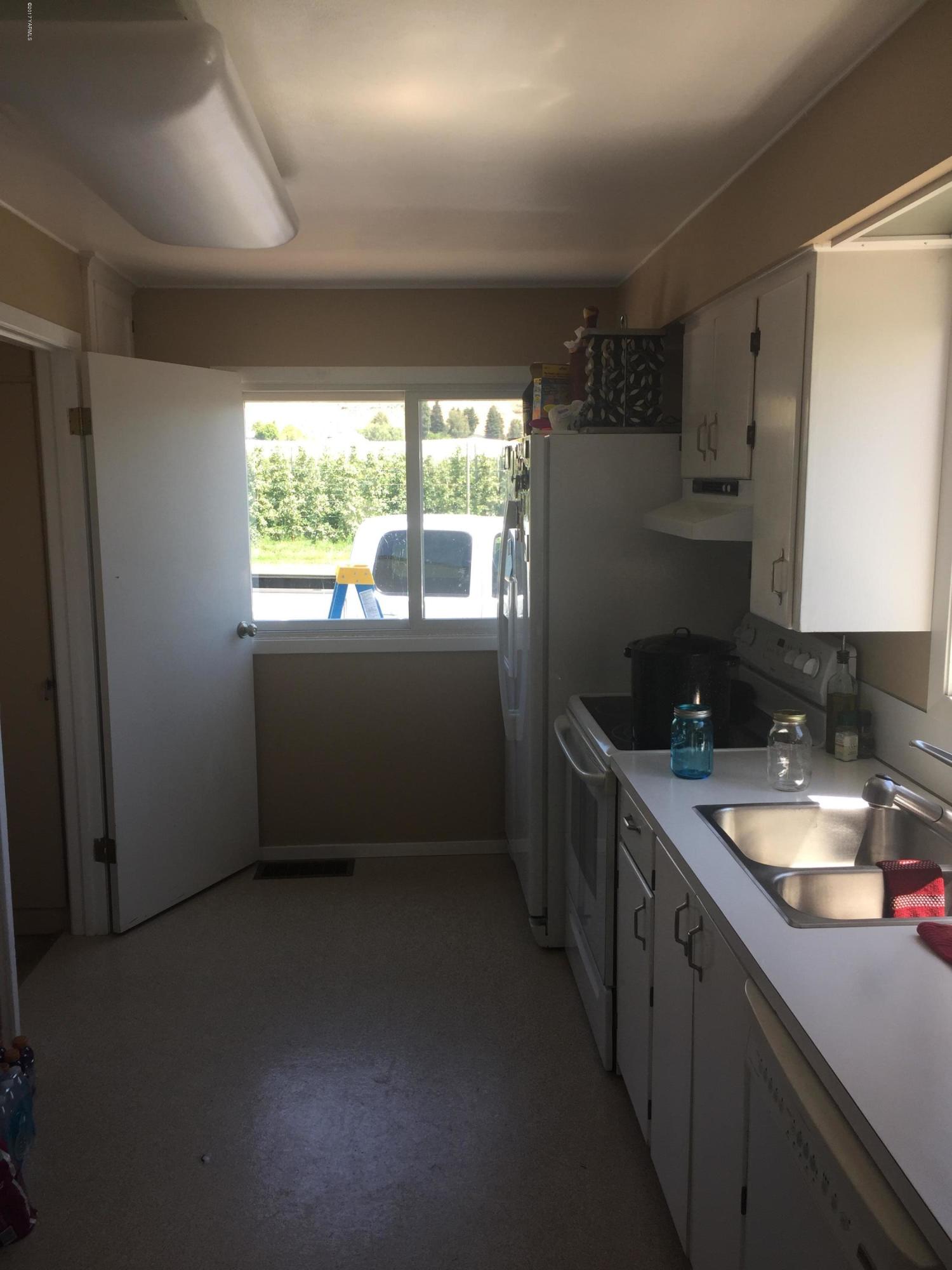 431 Allan Road Naches, WA 98937 - Photo 28 of 50 a kitchen with a sink a window and cabinets