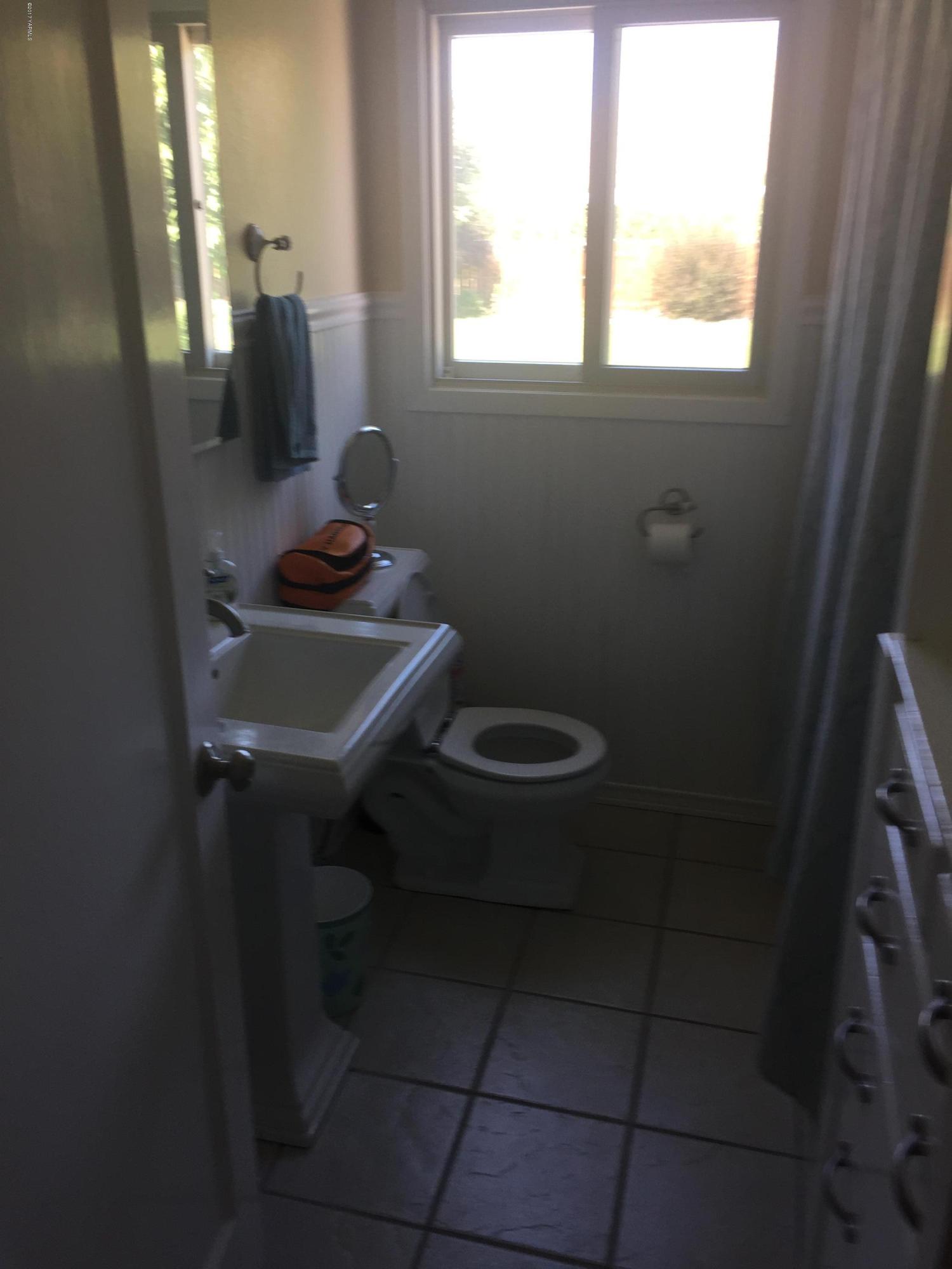431 Allan Road Naches, WA 98937 - Photo 36 of 50 a bathroom with a sink toilet and window