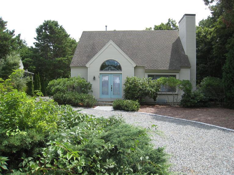 39 Summersea Road Mashpee, MA 02649 - Photo 2 of 18 a view of a white house with a yard and potted plants