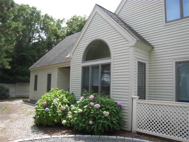39 Summersea Road Mashpee, MA 02649 - Photo 3 of 18 a view of a white house with a small yard and a large window