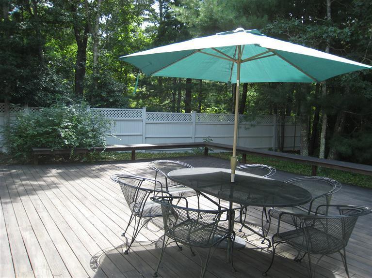 39 Summersea Road Mashpee, MA 02649 - Photo 5 of 18 a backyard of a house with table and chairs