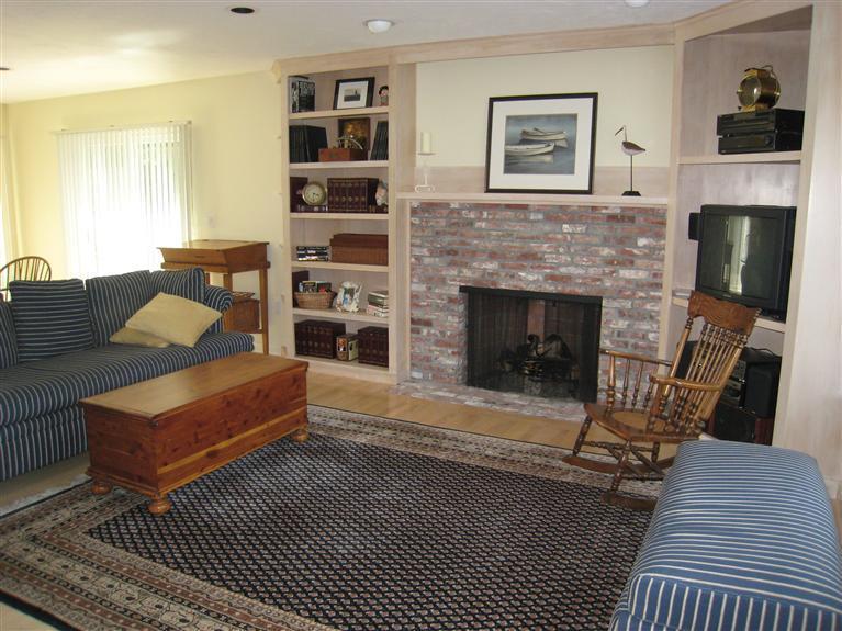 39 Summersea Road Mashpee, MA 02649 - Photo 7 of 18 a living room with furniture a flat screen tv and a fireplace