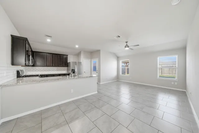 a view of a kitchen with a sink and a refrigerator