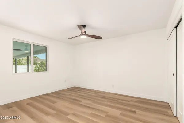 a view of empty room with wooden floor