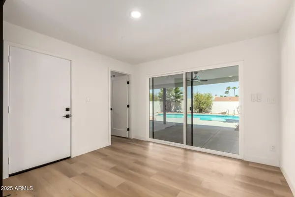 a view of an empty room with glass door